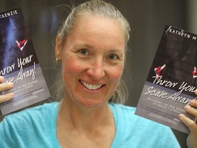 Author Kathryn McKenzie displays copies of her new book