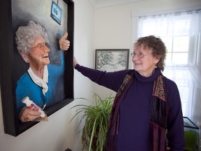 Gesina Laird-Buchanan with one of her "pultures" — a combination painting and sculpture of her mother playing bingo. (Meghan Balogh/Postmedia Network)