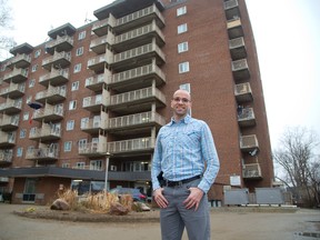 Abe Oudshoorn, of the London Homeless Coalition, stands outside an apartment building at 580 Dundas St. owned and operated by London and Middlesex Housing Corp. to provide affordable housing. (DEREK RUTTAN, The London Free Press)