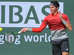 Milos Raonic returns a shot during his match with Bernard Tomic at the BNP Paribas Open at the Indian Wells Tennis Garden. (Jayne Kamin-Oncea/USA TODAY Sports)