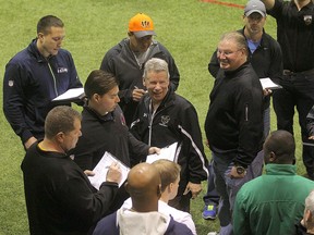 University of Manitoba Bisons head coach Brian Dobie (c) speaks with NFL scouts that were in Winnipeg, Man. to assess Bisons defensive tackle David Onyemata Monday March 14, 2016.
Brian Donogh/Winnipeg Sun/Postmedia Network