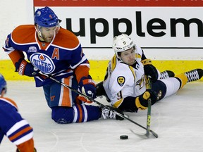 Taylor Hall and Nashville Predators winger Filip Forsberg battle for the puck during the first period Monday at Rexall Place. (Larry Wong)