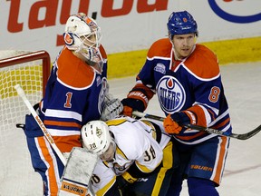Oilers goalie Laurent Brossoit and defenmceman Griffin REinhart battle Predators forward Victor Arvidsson during the second period of Monday's game at Rexall Place. (Larry Wong)