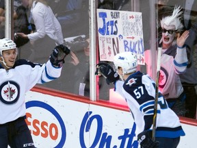 Winnipeg Jets Marko Dano, left, celebrates his goal with teammate Tyler Myers (57) during first period NHL action against the Vancouver Canucks in Vancouver on Monday, March 14, 2016. THE CANADIAN PRESS/Jonathan Hayward