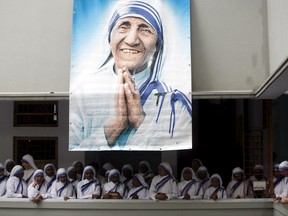 Catholic nuns from the order of the Missionaries of Charity gather under a picture of Mother Teresa during the tenth anniversary of her death in Kolkata, India, in this September 5, 2007 file photo. REUTERS/Jayanta Shaw/Files