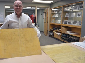 Elgin County Archives manager Stephen Francom carefully shows off an original 1819 map belonging to Col. Thomas Talbot. The map, along with 44 others in the Talbot Tract collection, were scanned and posted online by the local heritage agency. All 45 maps will be returned to the Archives of Ontario in Toronto Wednesday.