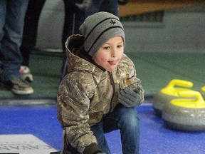 David Gough, Courier Press, Dgough@Postmedia.Com / Joey Delina, 7, throws a rock into the rings, during a Little Rocks session at the Sydenham Community Curling Club on Feb. 28.