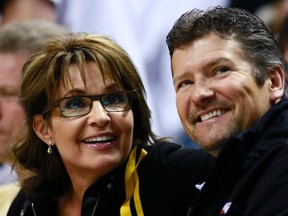 Former U.S. Republican vice-presidential candidate Sarah Palin and her husband Todd watch the NBA Eastern Conference final basketball playoff series between the Miami Heat and the Indiana Pacers in Indianapolis, Indiana, in this file photo taken May 26, 2013. (REUTERS/Brent Smith/Files)