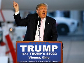 Republican presidential candidate Donald Trump holds a plane-side rally in a hanger at Youngstown-Warren Regional Airport in Vienna, Ohio, on March 14, 2016. (AP Photo/Gene J. Puskar)