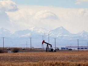 With the Rockies in the distance a  pumpjack operates on the prairie east of the Calgary city limits Monday March 14, 2016.  (Ted Rhodes/Postmedia)