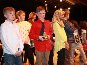 Grade three/four spelling bee contestant Ben Wright, from Aberarder Central School, hoists his runner-up trophy onstage after the completion of the Sarnia Spelling Bee.
CARL HNATYSHYN/SARNIA THIS WEEK