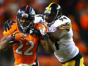 Denver Broncos running back C.J. Anderson (22) runs against Pittsburgh Steelers linebacker Lawrence Timmons during the AFC Divisional round playoff game at Sports Authority Field at Mile High. (Mark J. Rebilas/USA TODAY Sports)