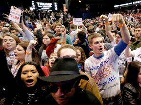 In this Friday, March 11, 2016 file photo, protesters of Republican presidential candidate Donald Trump, right, chant after a rally on the campus of the University of Illinois-Chicago, was canceled due to security concerns in Chicago. (AP Photo/Charles Rex Arbogast, File)