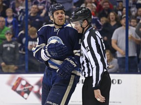 Columbus Blue Jackets defenceman Dalton Prout is assisted off the ice by an official after being called for a penalty against the Tampa Bay Lightning at Nationwide Arena in Columbus on March 13, 2016. (Aaron Doster/USA TODAY Sports)