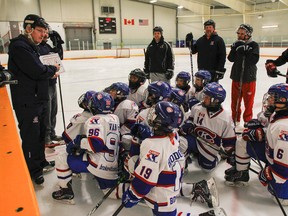 Players on the minor atom AA Kingston Canadians listen to coach Rick Carr before the start of practice at Cataraqui Community Centre on Tuesday. The Canadians are two points away from winning the Ontario Minor Hockey Association title. (Julia McKay/The Whig-Standard)