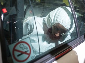 Ayanie Hassan Ali arrives in a police car at a Toronto court house on Tuesday, March 15, 2016. A man who allegedly said Allah instructed him to kill was charged Tuesday with stabbing and wounding two uniformed soldiers at a north Toronto military recruitment centre a day earlier. THE CANADIAN PRESS/Chris Young