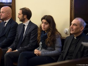 From left, Italian journalists Gianluigi Nuzzi and Emiliano Fittipaldi, public relations expert Francesca Chaouqui and Monsignor Angelo Lucio Vallejo Balda sit during their trial inside the Vatican. (L'Osservatore Romano/Pool Photo via AP, File)