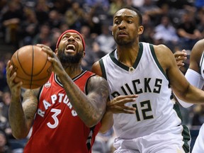 Raptors forward James Johnson (left) looks for a shot against Milwaukee Bucks forward Jabari Parker during the first quarter at BMO Harris Bradley Center on Tuesday. (USA TODAY Sports)