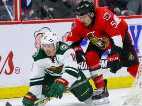 Ottawa Senators defenseman Cody Ceci (5) checks Minnesota Wild left wing Zach Parise (11) during NHL hockey action at the Canadian Tire Centre in Ottawa on Tuesday March 15, 2016. (Errol McGihon)