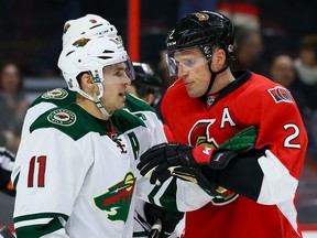 Senators defenceman Dion Phaneuf battles Minnesota Wild winger Zach Parise at the Canadian Tire Centre on March 15.