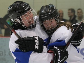 Jeanne Sauve Olympiens Camille Daeninck (l) and Paige Collins hug after winning the AAAA high school hockey final in Winnipeg, Man. Tuesday March 15, 2016. Jeanne Sauve defeated the Kelvin Clippers 1-0.
Brian Donogh/Winnipeg Sun/Postmedia Network