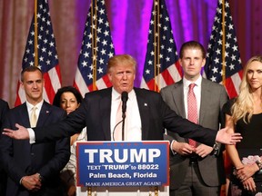 Republican U.S. presidential candidate Donald Trump speaks in front of his campaign manager Corey Lewandowski (L), his son Eric (R) and Eric's wife Lara Yunaska (R) after the Florida, Ohio, North Carolina, Illinois and Missouri primary elections during a news conference held at his Mar-A-Lago Club in Palm Beach, Florida March 15, 2016.  (REUTERS/Joe Skipper)