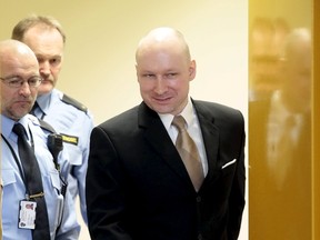 Mass killer Anders Behring Breivik is escorted by prison guards as he enters the court room in Skien prison, on March 15, 2016. (REUTERS/Lise Aserud/NTB scanpix)