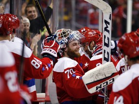 Washington Capitals goalie Braden Holtby (70) celebrates with his teammates after beating the Carolina Hurricanes Tuesday, March 15, 2016, in Washington. (AP Photo/Alex Brandon)