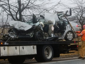 A tow truck driver straps down a car involved in a head-on two-vehicle crash that left multiple people dead on Hwy. 35, near Lifford Rd. in Kawartha Lakes, Ont., on Monday. (Jessica Nyznik/Examiner)