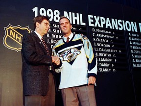 David Poile, general manager of the Nashville Predators, welcomes their first player, Mike Dunham, in a special NHL expansion draft June 26 at the Marine Midland Arena in Buffalo, NY. (Postmedia Network file photo)