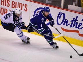 Winnipeg Jets forward Mark Scheifele (55) skates with the puck in front of Vancouver Canucks defenseman Christopher Tanev (8) during the third period at Rogers Arena. The Jets won 5-2.