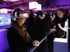 An attendee tries an Oculus-powered Samsung Gear VR headset during the French telecom operator Orange annual company's innovations show in Paris, March 16, 2016. REUTERS/Benoit Tessier
