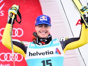 Erik Guay from Canada celebrates as third on the podium of the men's downhill at the FIS Alpine Ski World Cup Finals, in St. Moritz, Switzerland, on March 16, 2016. (Gian Ehrenzeller/Keystone via AP)