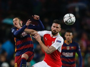 Barcelona’s Jordi Alba, left, fights for the ball with Arsenal’s Olivier Giroud during the Champions League match at the Camp Nou stadium in Barcelona Wednesday, March 16, 2016. (AP Photo/Manu Fernandez)