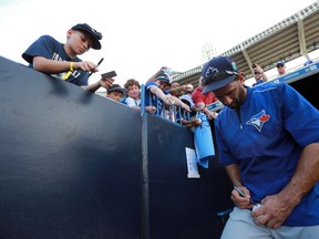 Toronto Blue Jays right fielder Jose Bautista signs autographs prior to Wednesday’s game against the New York Yankees at George M. Steinbrenner Field. (Kim Klement/USA TODAY Sports)