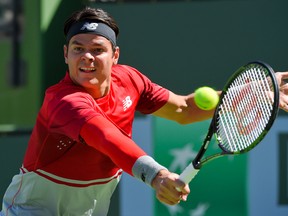 Milos Raonic returns to Tomas Berdych during the BNP Paribas Open in Indian Wells, Calif., on Wednesday, March 16, 2016. (Mark J. Terrill/AP Photo)