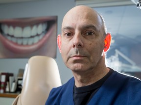 Dr. Larry Stanleigh mugs for a photo at his dental practice in Calgary, Alta., on Wednesday, March 16, 2016. Stanleigh is behind a lawsuit against the Alberta Dental Association that says his industry is being hampered by rules banning most advertising. Lyle Aspinall/Postmedia Network