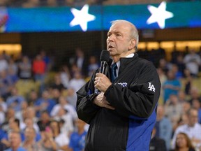 In this Sept. 18, 2015, file photo, Frank Sinatra, Jr. sings the national anthem prior to a baseball game between the Los Angeles Dodgers and the Pittsburgh Pirates in Los Angeles. Sinatra Jr., who carried on his famous father's legacy with his own music career, has died. He was 72. The Sinatra family said in a statement to The Associated Press that Sinatra died unexpectedly Wednesday, March 16, 2016, of cardiac arrest while on tour in Daytona Beach, Fla. (AP Photo/Mark J. Terrill)