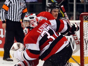 67’s forward Travis Barron crashes into teammate Leo Lazarev on March 16 at TD Place. The goalie left the OHL game against the Barrie Colts with an injury during the second period. (Darren Brown, Postmedia Network)