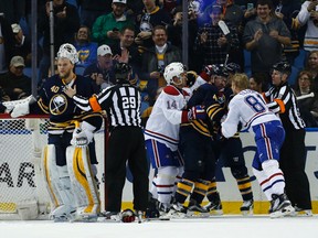 Sabres goalie Robin Lehner (left) is held by referee Ian Walsh as a large scuffle erupts between the Sabres and the Canadiens during second period NHL action in Buffalo on Wednesday, March 16, 2016. (Kevin Hoffman/USA TODAY Sports)