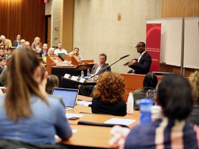 Professor Ubaka Ogbogu, with the Faculty of Law at the University of Alberta, speaks to a packed room as part of a panel discussion on Controlling Physician Assisted Death at the U of A's Law Centre in Edmonton, AB on Wednesday, March 16, 2015. TREVOR ROBB/Postmedia Network