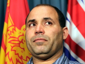 Algerian citizen Mohamed Harkat wipes away tears during a news conference on Parliament Hill in this May 15, 2014 file photo. (Tony Caldwell/Ottawa Sun/Postmedia Network)