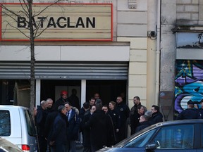 French lawmakers leave the Bataclan concert hall in Paris, Thursday, March 17, 2016. French lawmakers leading an investigation into the Nov. 13 attacks and some of the first responders at the Bataclan concert hall that night returned Thursday to re-enact the horror that left a total of 130 people dead across Paris. (AP Photo/Michel Euler)