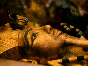 In this Nov. 5, 2015 file photo, one of Egypt's famed King Tutankhamun's golden sarcophagus is displayed at his tomb in a glass case at the Valley of the Kings in Luxor. Egypt's Antiquities Minister Mamdouh el-Damaty, says during a press conference Thursday, March 17, 2016, that analysis of scans of famed King Tut's burial chamber has revealed two hidden rooms that could contain metal or organic material. (AP Photo/Amr Nabil)