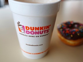A drink and a doughnut are seen at a Dunkin' Donuts location in Illinois. Former franchisees than ran coffee shops under the Dunkin' Donuts banner in Quebec will be paid nearly $18 million after a Supreme Court ruling. REUTERS/Jim Young