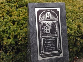 A marker noting the childhood home of writer H.P. Lovecraft is unveiled, near where his home once stood, following a ceremony on the 79th anniversary of the fantasy horror writer's death in Providence, R.I., Tuesday, March 15, 2016. (AP Photo/Jennifer McDermott)