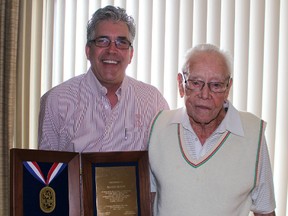 Rick Labelle, of the International Union of Painters and Allied Trades Local 1590, presents a plaque to its longest-serving member Archie Hoven Thursday. Now a 96-year-old retired painter, Hoven once worked on the construction site of the former Dow plant back in the 1940s. (Barbara Simpson/Sarnia Observer/Postmedia Network)