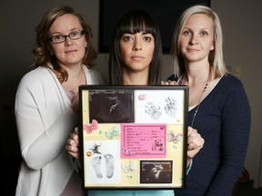 Luke Hendry/The Intelligencer
Butterfly Run organizers Barb Matteucci, left, and Loralee McInroy flank fellow organizer Beth Primeau in Belleville Friday. Primeau holds a collection of images and other items related to the stillbirth of her daughter, Charlie, in November 2015. They're raising funds to provide more bereavement supports for parents.