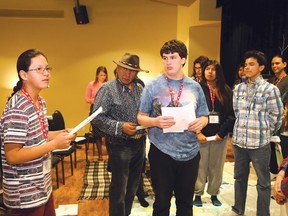 Theland Kicknosway, left, advises participants during a Blanket exercise at the Canadian Roots Exchange annual conference at the Steelworkers Hall in Sudbury, Ont. on Thursday March 17, 2016. John Lappa/Sudbury Star/Postmedia Network