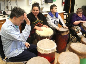 Yessica Belsham, second from left, from the Kingston Drum Circle, leads clients at Ongwanada’s Crescent Community Centre on Thursday in a drumming workshop. They meet weekly to play the drums as a way of self-expression. (Michael Lea/The Whig-Standard)